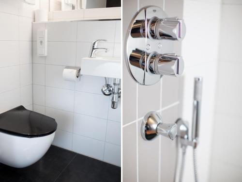a bathroom with a toilet and a sink at Moment Hotels in Malmö