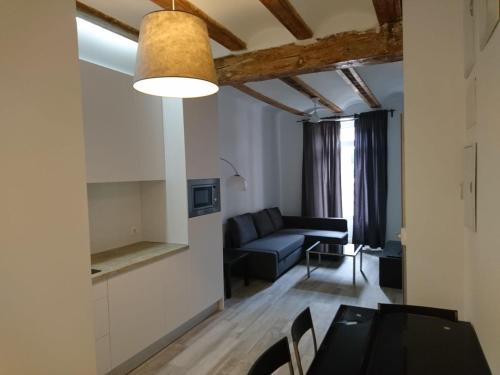 a living room with a table and a couch at NWT Central Station Apartments in Valencia