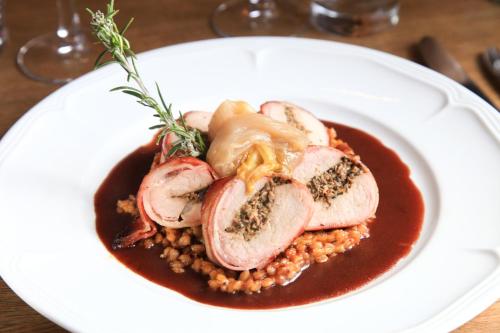 a plate of food with meat and sauce on a table at Domaine Les Mejeonnes in Valaurie