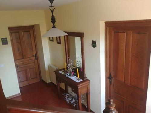 a room with a mirror and a table with a lamp at El Pedroso in Santillana del Mar