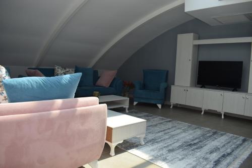 a living room with a couch and a tv at Nar Palace in Istanbul