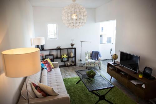 a living room with a white couch and a chandelier at Apt. Downtown 2 in Funchal