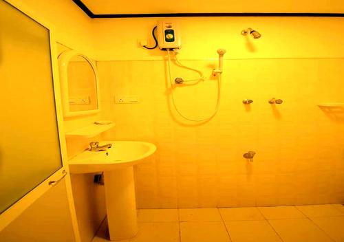 a bathroom with a shower and a sink at Yuthika Resort in Negombo