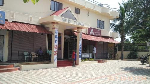 a building with a restaurant in front of it at Hotel Varsha Hampi in Hampi