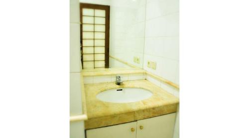 a bathroom with a sink and a mirror at Villa Kota Bunga Ade Type Jepang - 0222 in Cibadak