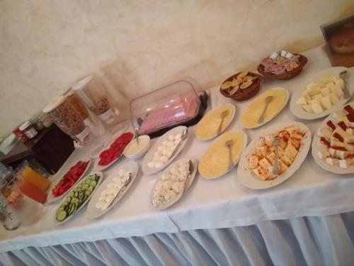 a table with different types of food on plates at Dwa Bratanki in Rzeszów
