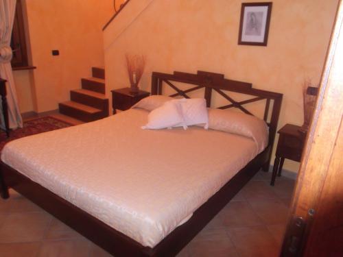 a bedroom with a bed with a staircase in it at Agriturismo Casal Grande in Canepina