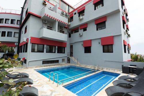 a building with a swimming pool in front of a building at Hôtel Jawharat El Jadida in El Jadida