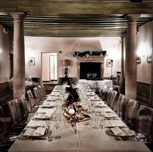 a long table in a room with chairs and glasses at Hotel Villa Condulmer in Mogliano Veneto