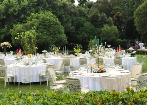 a group of tables with white linens and chairs at Hotel Villa Condulmer in Mogliano Veneto