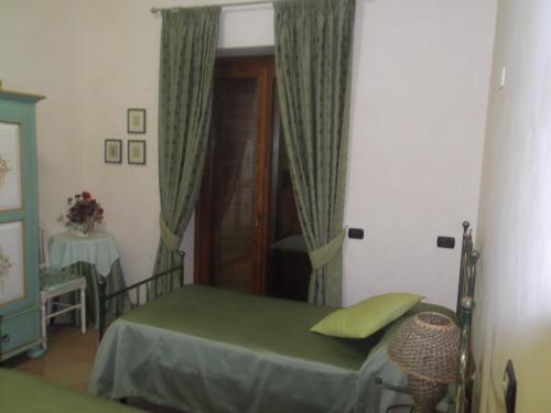 a bedroom with a bed and a door with curtains at Agriturismo Casal Grande in Canepina