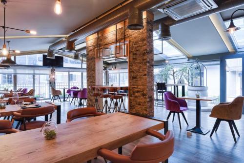 a restaurant with a wooden table and chairs at Hotel Galija in Pula