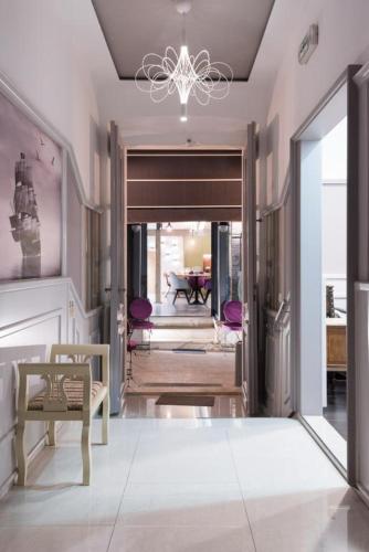 a living room with a hallway with a chandelier at Hotel Galija in Pula