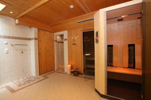 a bathroom with a shower and a glass door at Villa Mark in Ischgl