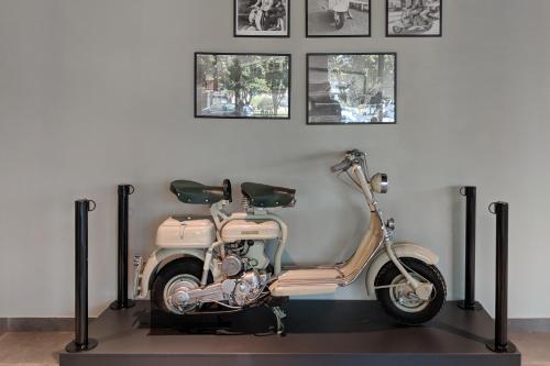 a scooter is on display in a room at MEININGER Milano Lambrate in Milan