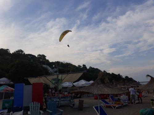 a person is flying a kite on a beach at Apartment Sea Star in Burgas