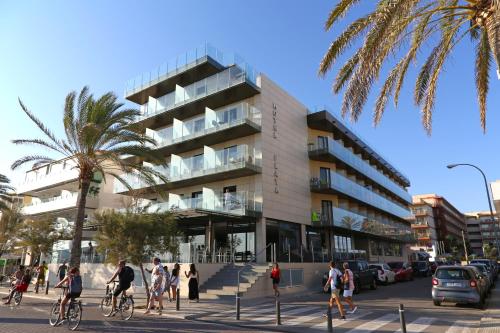 a group of people riding bikes in front of a building at Hotel Eden Palma Playa Adults Only in Can Pastilla