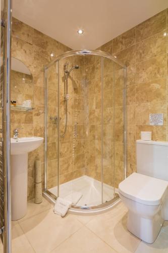 a bathroom with a shower and a toilet and a sink at Autumn House in Cambridge