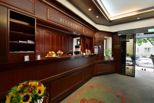 a lobby with a reception counter in a building at Hotel Imperial in Cologne