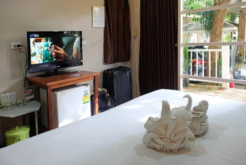 a bedroom with a bed with a toy animal on it at Reera Resort in Hua Hin