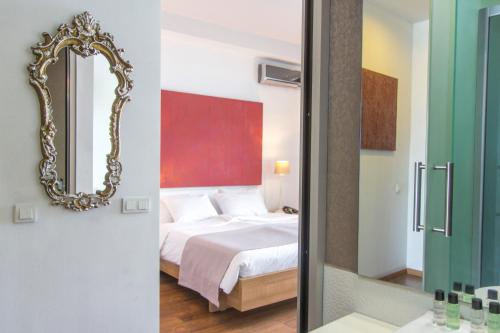 a bedroom with a bed and a mirror at Tbilisi View Hotel in Tbilisi City