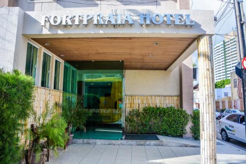 a front entrance to a hotel with a sign on it at Fortpraia Hotel in Fortaleza