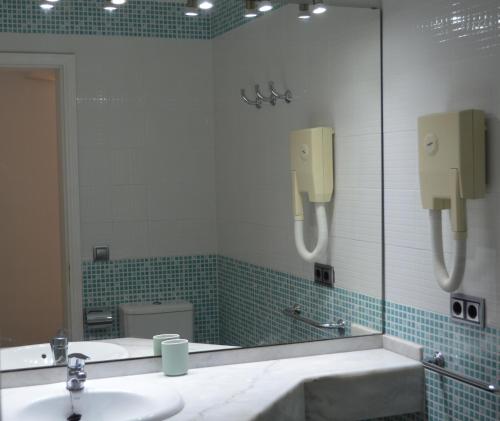 a bathroom with a mirror and a sink at The Peaches Bungalows 45 & 46 in Maspalomas