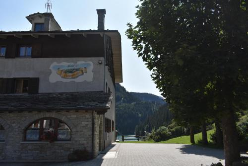 a building with a sign on the side of it at Albergo Mangusta in Madesimo