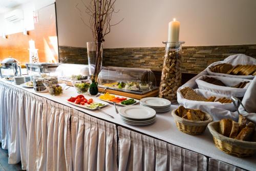 a buffet with bread and food on a table at Hotel Marc Aurel - Vienna City Center in Vienna