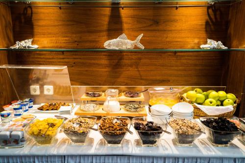 a buffet of desserts and other food on a table at Hotel Marc Aurel - Vienna City Center in Vienna