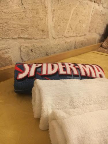 a pile of towels sitting on top of a bed at Palazzo Savoia 1856 in Fasano
