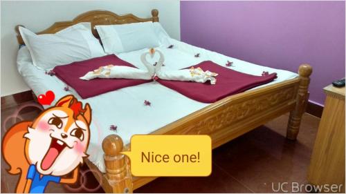 a bedroom with a bed with aiggermsg at Breezy Land Residency (Nidhi Sri & k.k resort) in Yercaud