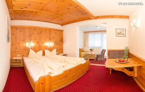 A bed or beds in a room at Hotel Berghof