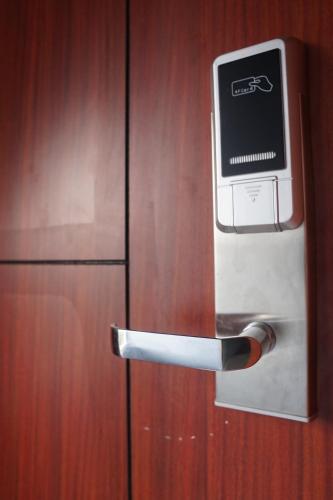 a refrigerator with a television on the door at Cemerlang Inn in Palembang