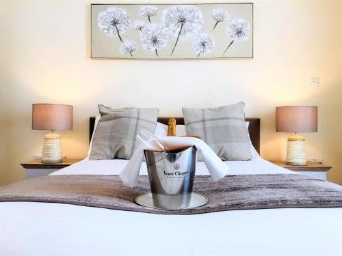 a bedroom with two beds with a doll in a bucket at Ice House Apartments in Swansea