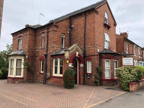 an old brick building on a brick street at South Park Guest House in Lincoln