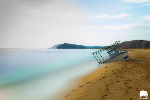 a boat sitting on the shore of a body of water at B&B Le Foglie D'Argento in Caltabellotta