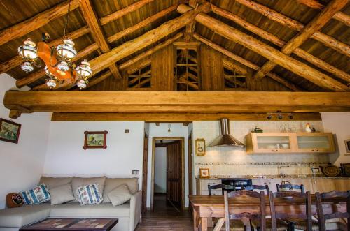 una sala de estar con techo con vigas de madera. en Borda Fuertes, en Albella