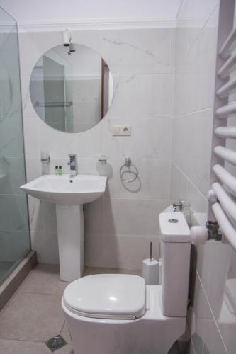 a bathroom with a toilet and a sink and a mirror at Tbilisi View Hotel in Tbilisi City
