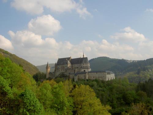 a castle on top of a hill with trees at Ferienhaus Chalet Cottage Ourtalblick 2km von Vianden-Lux in Roth