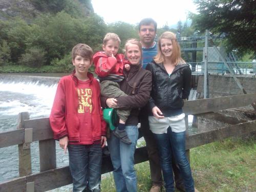 a family poses for a picture next to a river at Ferienhaus Waldsicht in Flachau
