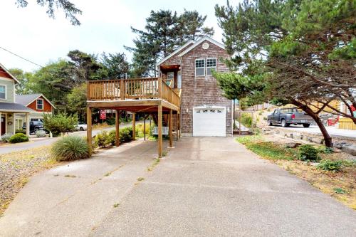 a house with a deck on the side of a sidewalk at Beach house with a park in Lincoln City