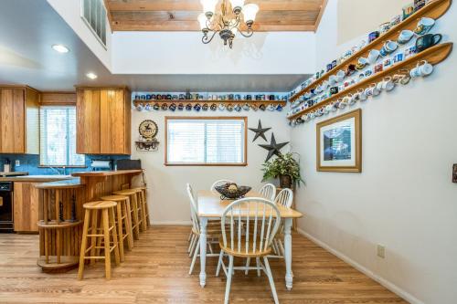 a kitchen with a dining room table and chairs at Sparrow Cove in Shaver Lake