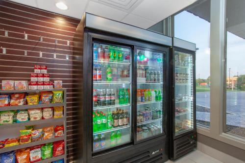 a refrigerator filled with lots of soda and drinks at Wyndham Garden Fort Wayne in Fort Wayne