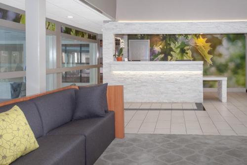 a living room with a couch and a fireplace at Wyndham Garden Fort Wayne in Fort Wayne