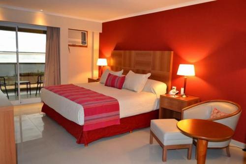 A bed or beds in a room at Condado Hotel Casino Paso de la Patria
