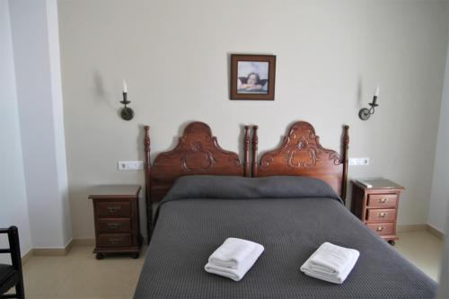 a bedroom with a bed with two white towels on it at Easy Nerja Bronce in Nerja