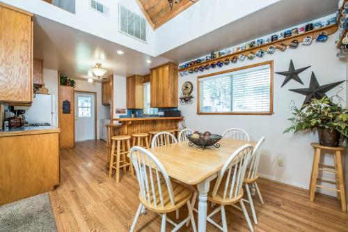 a kitchen and dining room with a wooden table and chairs at Sparrow Cove in Shaver Lake