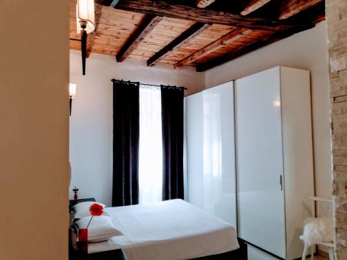 um quarto com uma cama branca e cortinas pretas em Althamer Palace Apartments em Arco