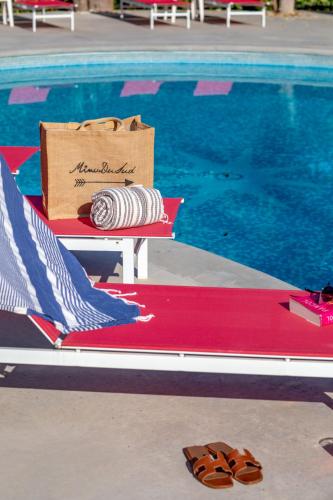 a box sitting on a bench next to a swimming pool at Servotel Castagniers in Castagniers